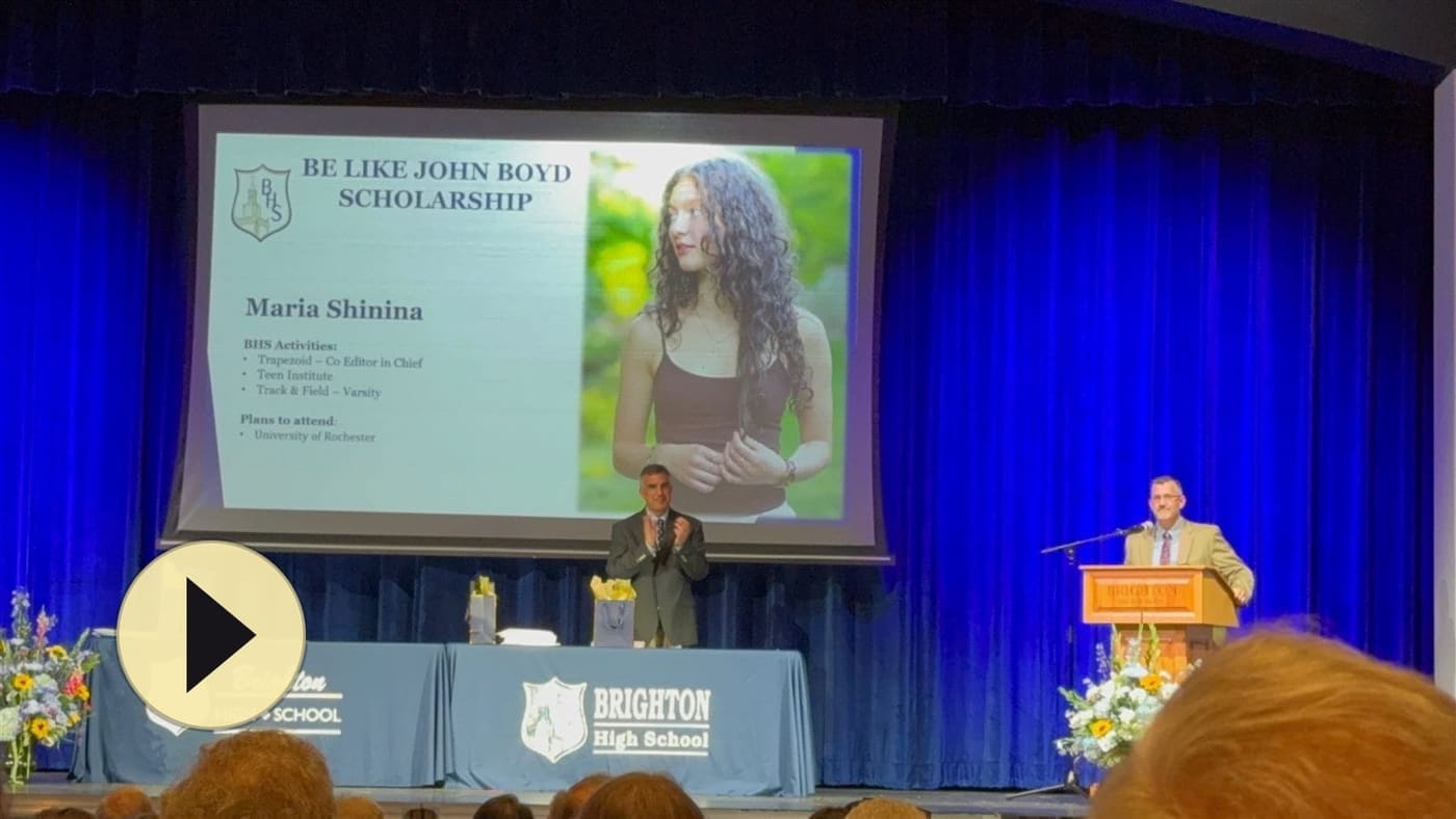 Play the 2026 Be Like John Boyd Scholarship presentation — Maria Shinina's award announced on stage at Brighton High School